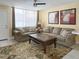 Comfortable living room featuring neutral tones, tile floors, and large windows at 7645 Sun Island S Dr # 207, South Pasadena, FL 33707
