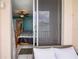 View from the lanai into the main bedroom showcasing a ceiling fan, neutral paint, and a decorative bedspread at 7645 Sun Island S Dr # 207, South Pasadena, FL 33707