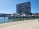 Exterior shot of the marina with several boats docked and a tall condominium in the background at 7645 Sun Island S Dr # 207, South Pasadena, FL 33707