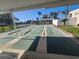 View of outdoor shuffleboard courts providing residents with a recreational space at 7645 Sun Island S Dr # 207, South Pasadena, FL 33707