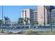 Outdoor view of tennis courts at 'The Presidential' condos, showing the court and adjacent building at 7645 Sun Island S Dr # 207, South Pasadena, FL 33707