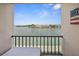 A full water view is visible from the lanai featuring an outdoor seating area and black railing at 7645 Sun Island S Dr # 207, South Pasadena, FL 33707