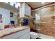 Bathroom with a glass enclosed shower, granite countertop, and white vanity at 8198 Terrace Garden N Dr # 109, St Petersburg, FL 33709