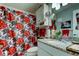 Bathroom featuring a white cabinet, granite countertops, a mirror, and a red floral shower curtain at 8198 Terrace Garden N Dr # 109, St Petersburg, FL 33709
