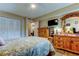 Bedroom with a comfortable bed, wooden dresser and furnishings, plus a doorway to another room at 8198 Terrace Garden N Dr # 109, St Petersburg, FL 33709