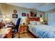 Well-decorated bedroom features a comfortable bed, wooden furniture, and a window for natural light at 8198 Terrace Garden N Dr # 109, St Petersburg, FL 33709