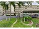 Exterior shot of The Radcliffe building with lush landscaping and covered parking at 8198 Terrace Garden N Dr # 109, St Petersburg, FL 33709
