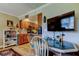 Eat-in kitchen with wood cabinets, laminate floors and a big screen TV at 8198 Terrace Garden N Dr # 109, St Petersburg, FL 33709