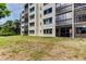 Exterior building view with green lawn; ground floor condos offer easy access to the outdoors at 8198 Terrace Garden N Dr # 109, St Petersburg, FL 33709