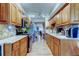 Open kitchen featuring stainless steel appliances, granite counters, and wood cabinets at 8198 Terrace Garden N Dr # 109, St Petersburg, FL 33709