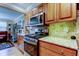 Updated kitchen showcasing granite counters, wood cabinets, and modern appliances at 8198 Terrace Garden N Dr # 109, St Petersburg, FL 33709