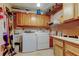 Functional laundry room with washer, dryer, sink, and ample cabinet storage for convenience at 8198 Terrace Garden N Dr # 109, St Petersburg, FL 33709