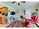 Cozy living room features wood floors, ceiling fan, and a view to another room at 8198 Terrace Garden N Dr # 109, St Petersburg, FL 33709