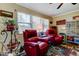 Cozy living room with natural light, comfortable seating, and a ceiling fan at 8198 Terrace Garden N Dr # 109, St Petersburg, FL 33709