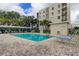 Community pool with lounge chairs, cabana, and well-kept landscaping at 8198 Terrace Garden N Dr # 109, St Petersburg, FL 33709