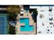 Overhead view of a community pool and hot tub surrounded by lounge chairs and a tennis court at 8198 Terrace Garden N Dr # 109, St Petersburg, FL 33709