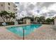 Community swimming pool with lounge chairs, and well-maintained landscaping at 8198 Terrace Garden N Dr # 109, St Petersburg, FL 33709