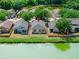 Aerial shot showcasing the home's backyard with a scenic view of a tranquil pond at 8420 Deer Chase Dr, Riverview, FL 33578