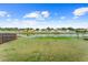 View of the backyard with a long pond behind the property and a wood fence on the left side of the lot at 8420 Deer Chase Dr, Riverview, FL 33578