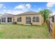 Backyard view of the property showing the siding, windows, sliding glass doors and the air conditioning condenser at 8420 Deer Chase Dr, Riverview, FL 33578