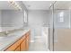 Bright bathroom featuring double sinks, soaking tub, and glass-enclosed shower at 8420 Deer Chase Dr, Riverview, FL 33578
