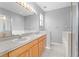 Bright bathroom featuring double sinks, soaking tub, and glass-enclosed shower at 8420 Deer Chase Dr, Riverview, FL 33578