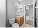 A bathroom featuring a toilet, wooden vanity and mirror at 8420 Deer Chase Dr, Riverview, FL 33578