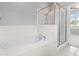 Bathroom showcases a tile-surround garden tub and glass-enclosed shower at 8420 Deer Chase Dr, Riverview, FL 33578