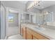 Bright bathroom featuring double sinks, soaking tub, and glass-enclosed shower at 8420 Deer Chase Dr, Riverview, FL 33578