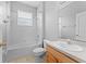 Bathroom features a shower-tub combo with a white vanity, toilet and tile flooring at 8420 Deer Chase Dr, Riverview, FL 33578