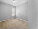 A bright bedroom featuring neutral walls and carpet, with a window offering natural light at 8420 Deer Chase Dr, Riverview, FL 33578