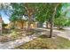 View of a well-maintained home featuring mature trees and a paved driveway at 8420 Deer Chase Dr, Riverview, FL 33578