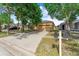 View of a well-maintained home featuring mature trees and a paved driveway at 8420 Deer Chase Dr, Riverview, FL 33578