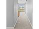 Hallway view looking out towards a kitchen with bright windows, offering great natural light at 8420 Deer Chase Dr, Riverview, FL 33578