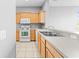 A kitchen features wood cabinets, white appliances and modern countertops at 8420 Deer Chase Dr, Riverview, FL 33578