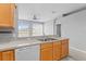 Bright kitchen features stainless steel sink, gray countertops and wood cabinetry at 8420 Deer Chase Dr, Riverview, FL 33578