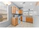 Kitchen featuring wood cabinets and white appliances, with a window offering natural light at 8420 Deer Chase Dr, Riverview, FL 33578