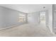 Bright living room showcasing neutral walls, carpet floors, a large window, and an elegant chandelier at 8420 Deer Chase Dr, Riverview, FL 33578