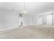 Bright living room showcasing neutral walls, carpet floors, arched entryways, and an elegant chandelier at 8420 Deer Chase Dr, Riverview, FL 33578