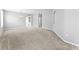 Spacious living room featuring neutral walls, plush carpeting, arched entryways, and a decorative chandelier at 8420 Deer Chase Dr, Riverview, FL 33578