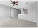 Open living room with gray walls and neutral carpeting leads to kitchen area at 8420 Deer Chase Dr, Riverview, FL 33578