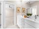Bright bathroom with double sink vanity, ample counter space, and view into the adjacent bedroom at 916 Hemingway Cir, Tampa, FL 33602