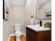 Modern half bathroom features wood vanity and framed mirror at 916 Hemingway Cir, Tampa, FL 33602
