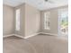 Spacious bedroom with neutral tones, plush carpeting, ample natural light, and a private exterior door at 916 Hemingway Cir, Tampa, FL 33602