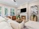 Cozy living room with a fireplace, comfortable seating, and hardwood floors at 916 Hemingway Cir, Tampa, FL 33602
