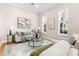 Bright living room with hardwood floors, neutral furnishings, and large windows at 916 Hemingway Cir, Tampa, FL 33602