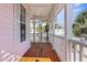 Charming porch with wooden floors and a classic white railing, offering a glimpse of neighborhood houses at 916 Hemingway Cir, Tampa, FL 33602
