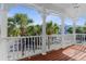 Upper porch view showcasing the tropical scenery and colorful neighborhood homes in the distance at 916 Hemingway Cir, Tampa, FL 33602