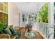 Inviting porch with comfortable seating, a glass table, and views of the lush tropical landscape at 916 Hemingway Cir, Tampa, FL 33602