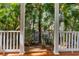 Covered porch with wood floors and views of palm trees and street at 916 Hemingway Cir, Tampa, FL 33602
